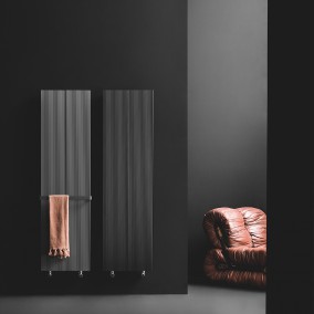 loft radiator placed on a red wall